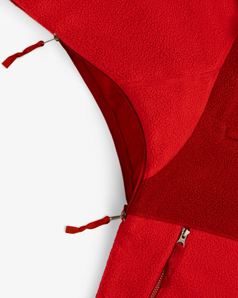 Close-up of ALD/The North Face ’95 Denali Half-Zip Fleece Pullover, red with two unzipped zippers, on white background.