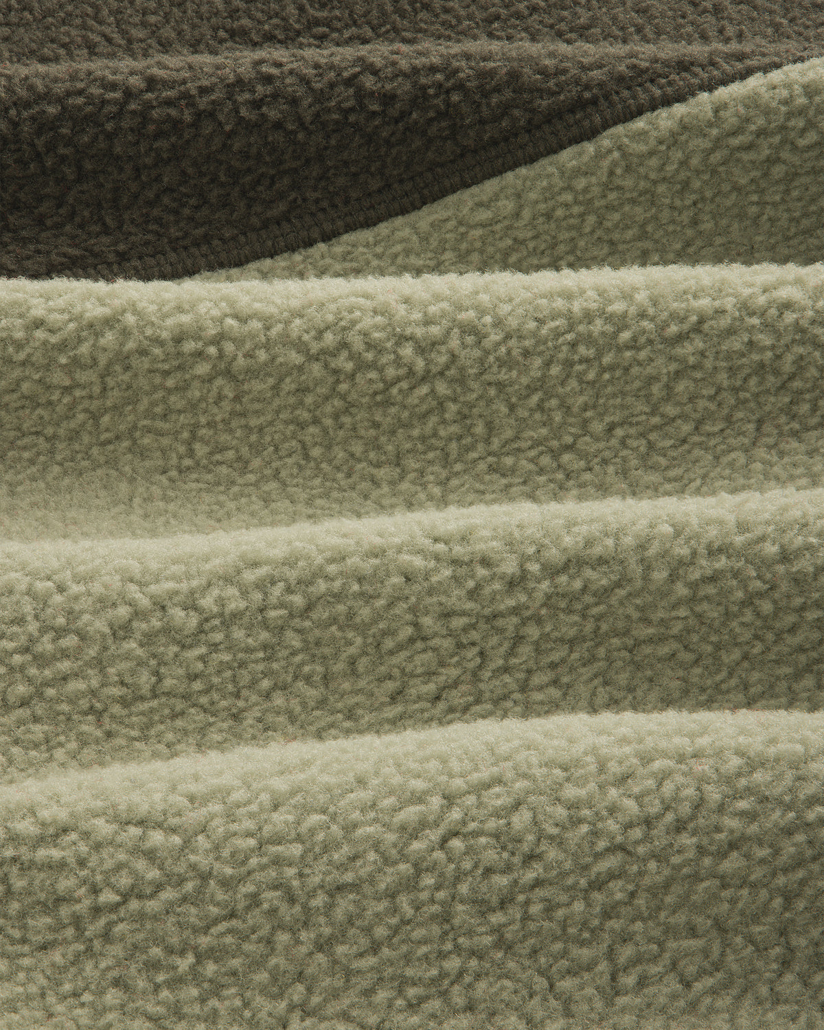 Close-up of olive/sage ALD/The North Face ’95 Denali Half-Zip Fleece Pullover with deep, soft textured ridges.