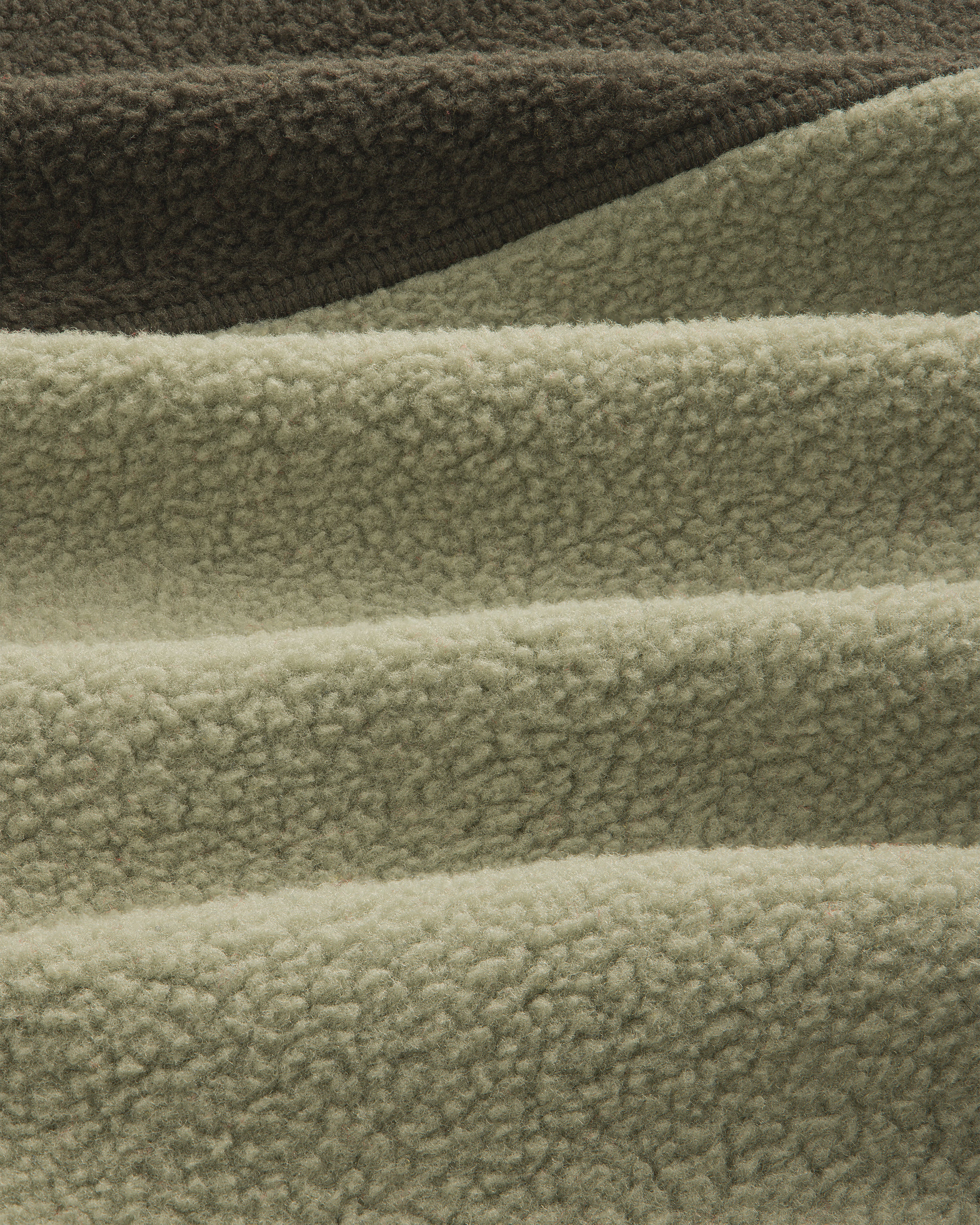 Close-up of olive/sage ALD/The North Face ’95 Denali Half-Zip Fleece Pullover with deep, soft textured ridges.