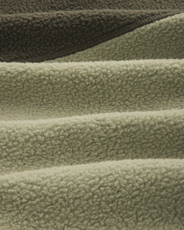 Close-up of olive/sage ALD/The North Face ’95 Denali Half-Zip Fleece Pullover with deep, soft textured ridges.