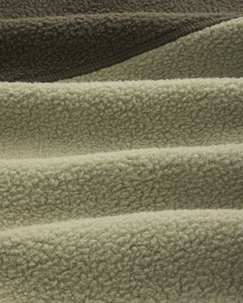 Close-up of olive/sage ALD/The North Face ’95 Denali Half-Zip Fleece Pullover with deep, soft textured ridges.