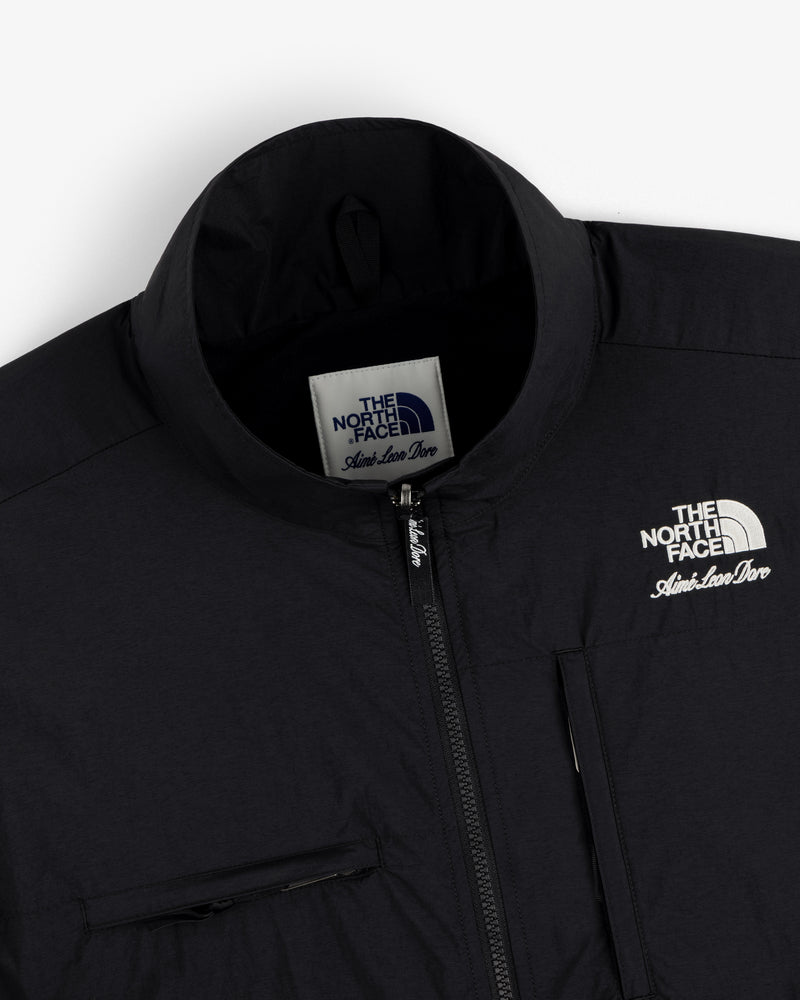 Close-up of a black ALD / The North Face Nylon Denali Jacket, showing zipper, chest pocket, and label.