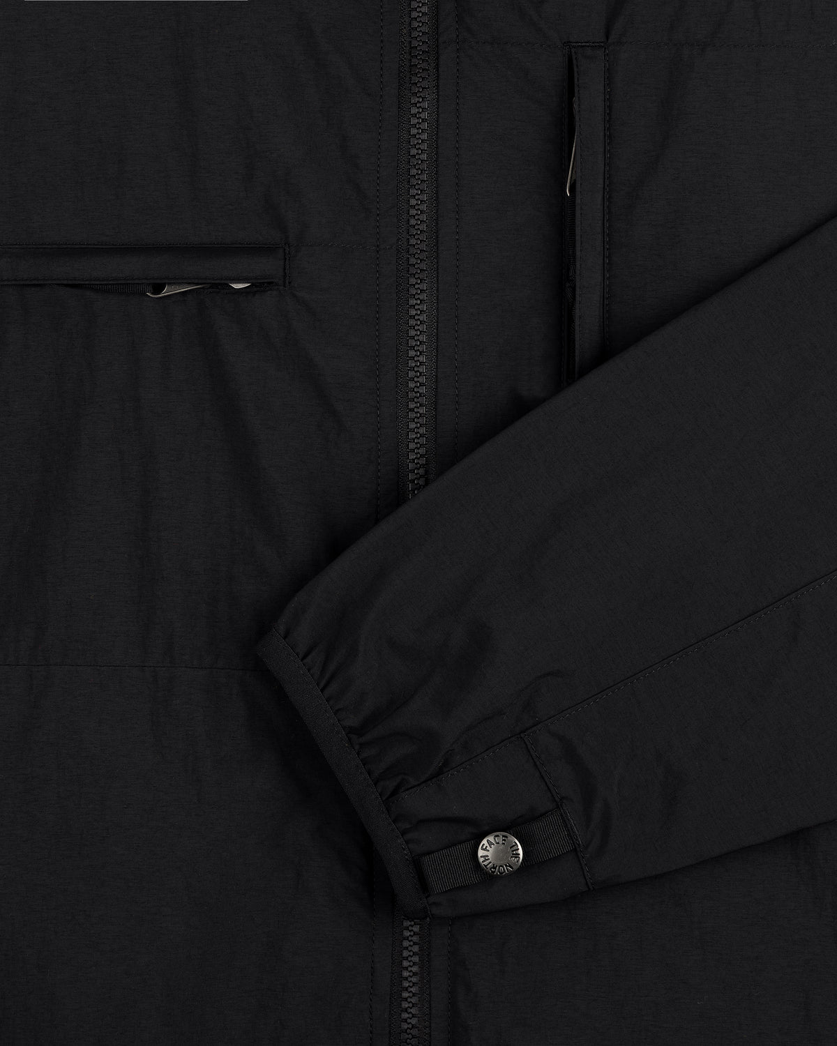 Detailed view of ALD / The North Face Nylon Denali Jacket sleeve with snap cuff, zipper, and chest zip pocket.