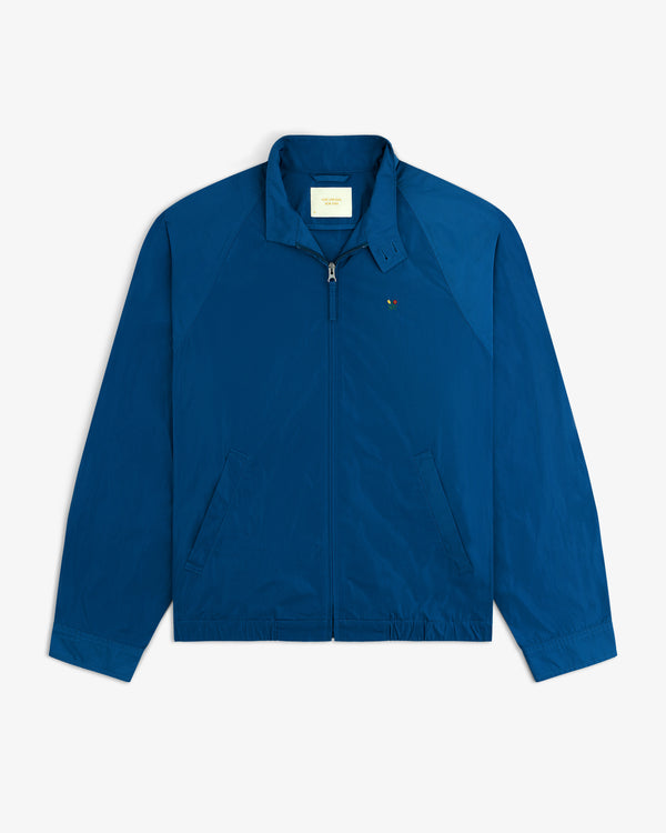 Crest Nylon Windbreaker: Blue zip-up with collar, long sleeves, slanted pockets & chest logo.