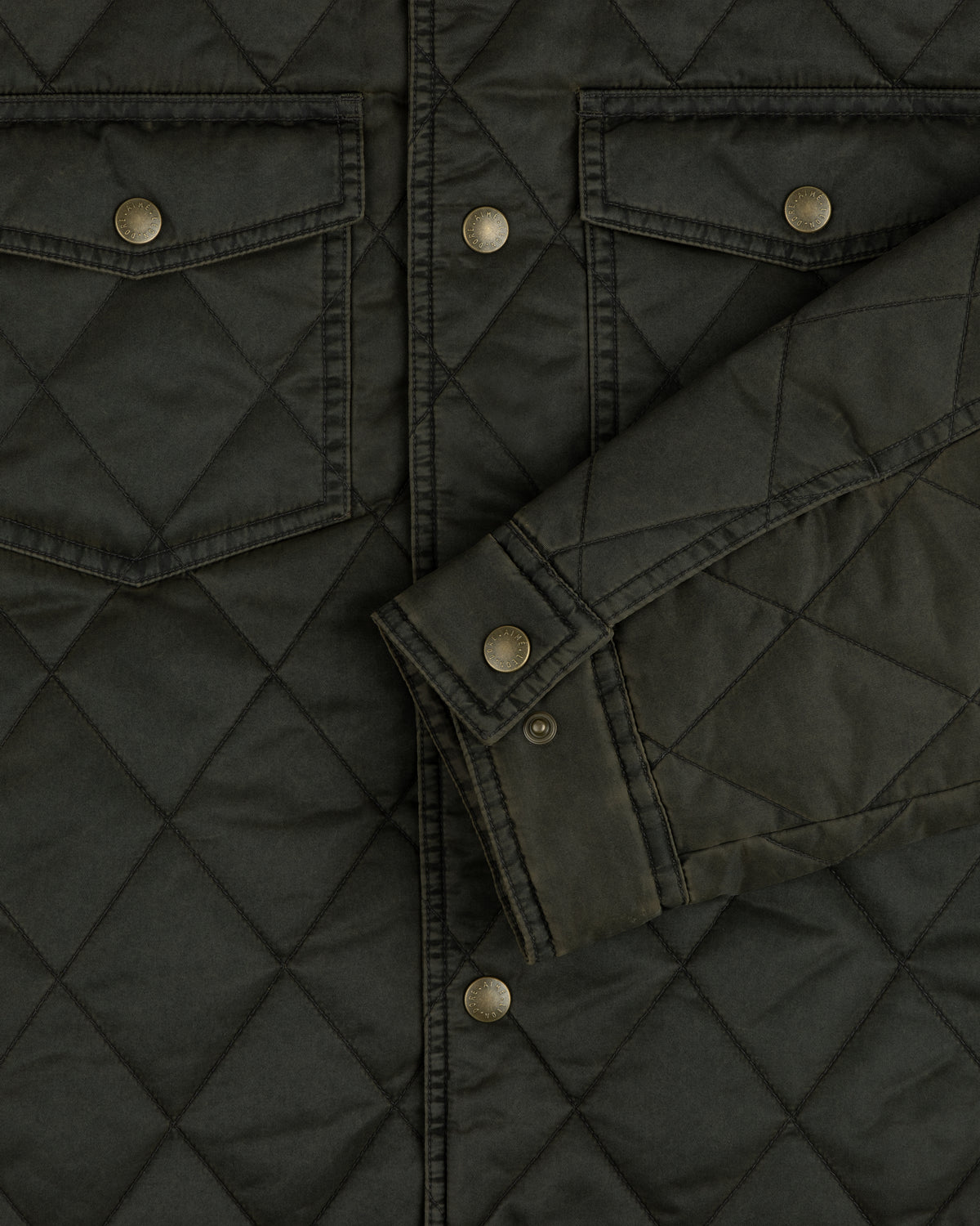 Olive green Quilted Trucker Jacket with metal buttoned chest pockets and sleeve cuffs.