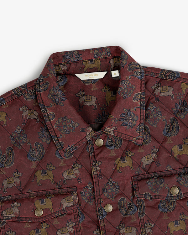 Quilted Trucker Jacket in maroon featuring a repeating pattern of cows, roosters, and floral motifs.