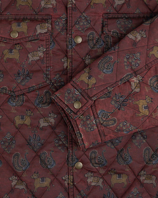 Quilted Trucker Jacket in maroon, featuring a repeating pattern of animals, floral motifs, and metal buttons.