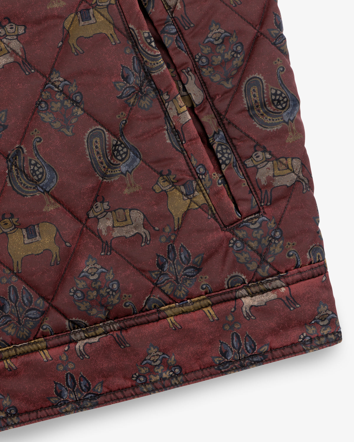 Maroon Quilted Trucker Jacket featuring a repeating pattern of animals and floral motifs.