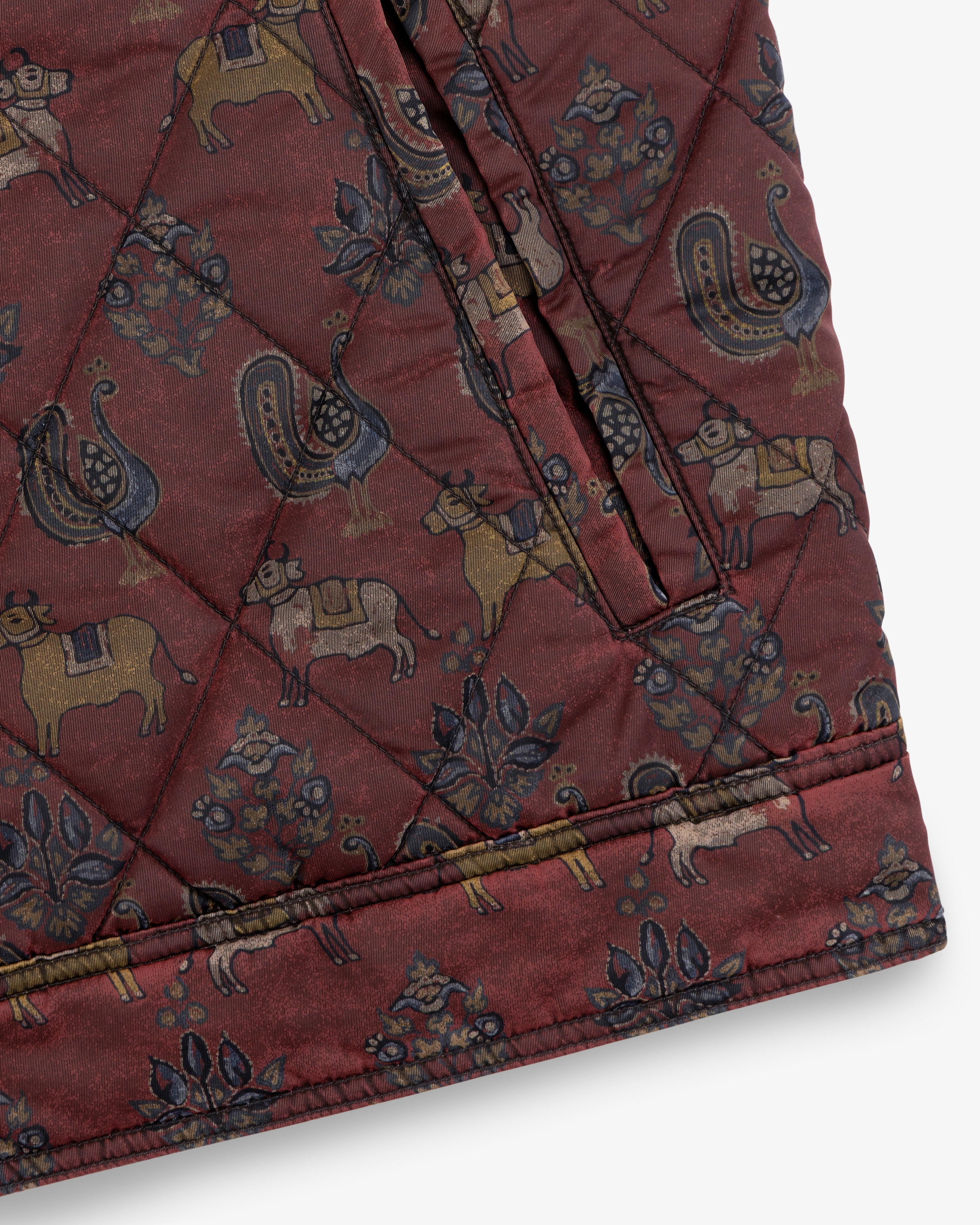 Maroon Quilted Trucker Jacket featuring a repeating pattern of animals and floral motifs.