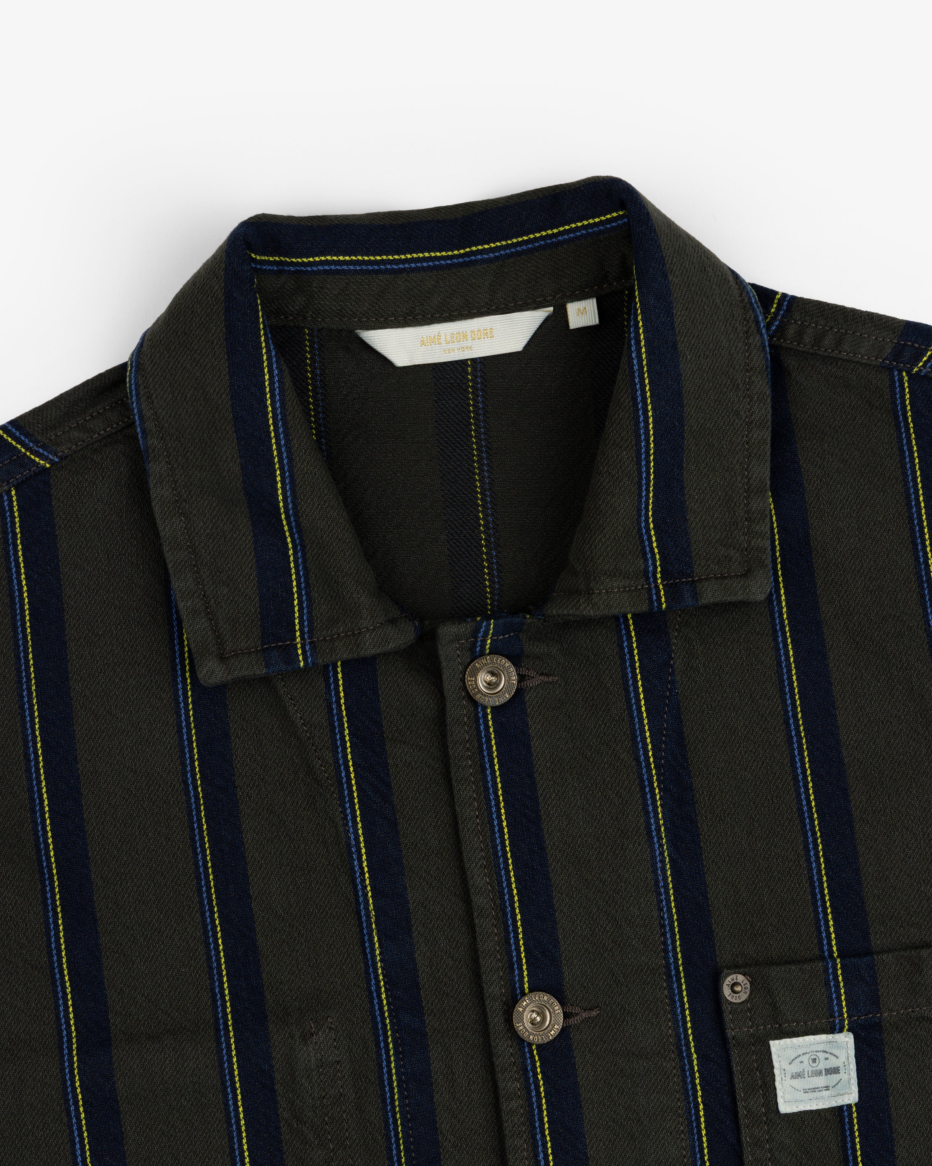 Striped Denim Chore Jacket with blue and yellow stripes, button front, collar, and chest pocket label.