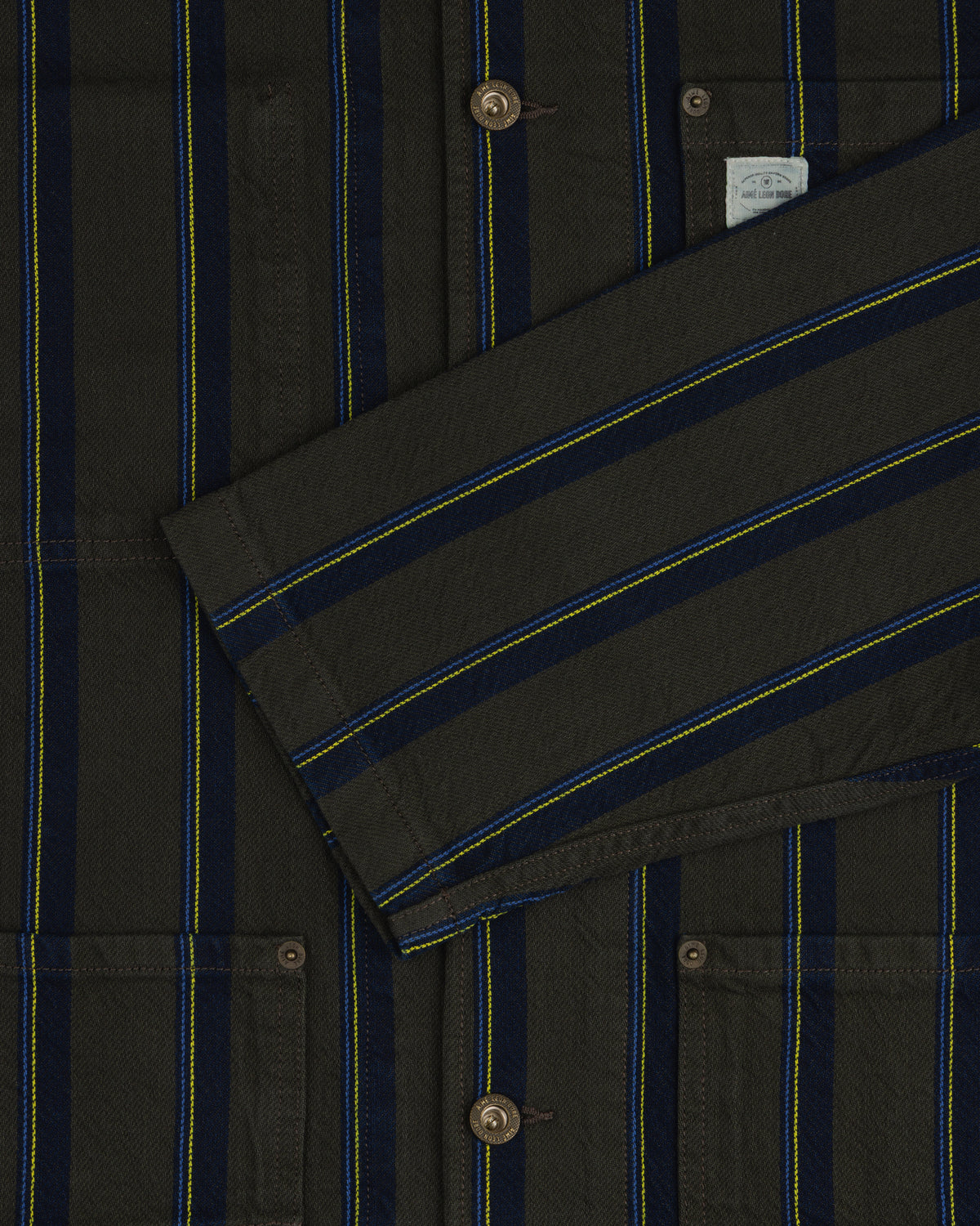 Close-up of the Striped Denim Chore Jacket featuring blue, yellow, and black stripes, buttons, and pockets.