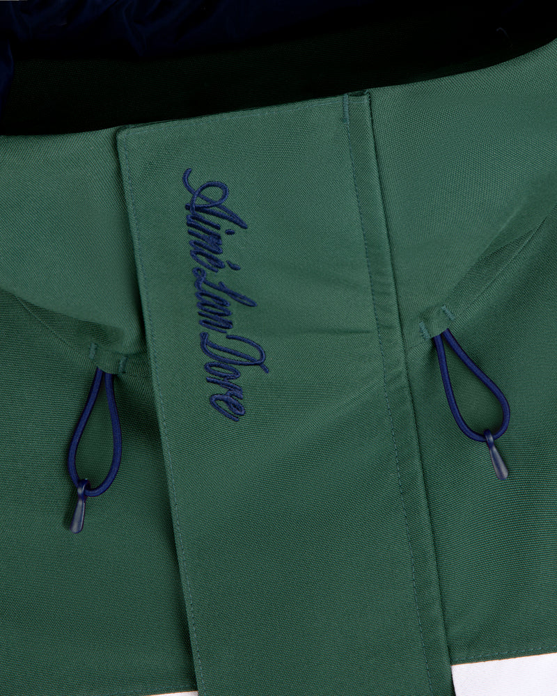 Close-up of the GORE-TEX Striped Sailing Jacket in green with blue drawstrings and Aimé Leon Dore on the flap.