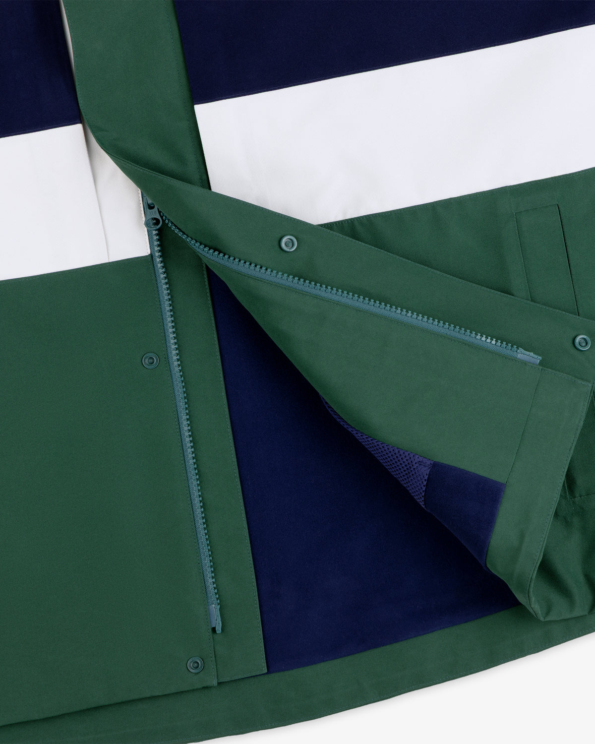 Close-up of the GORE-TEX Striped Sailing Jacket in green, navy, and white with open zipper and snap button flap.