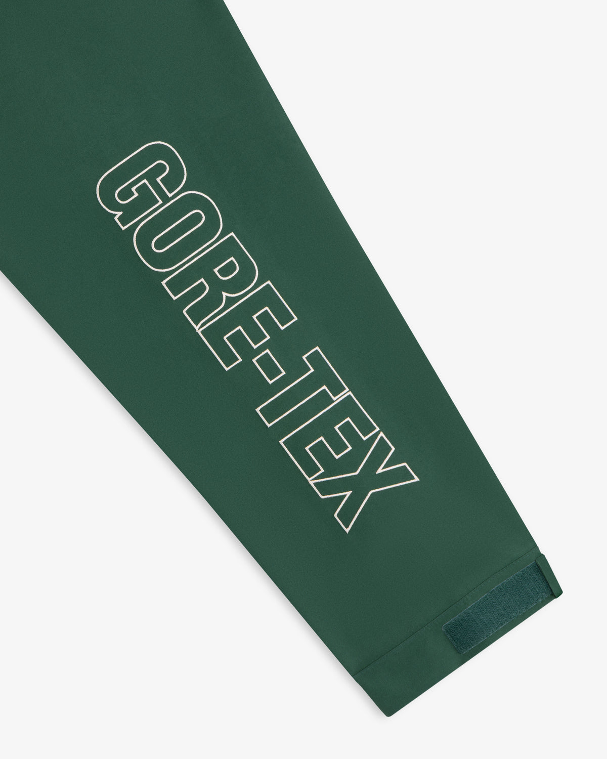 Green sleeve on the GORE-TEX Striped Sailing Jacket with bold white logo and Velcro cuff strap.