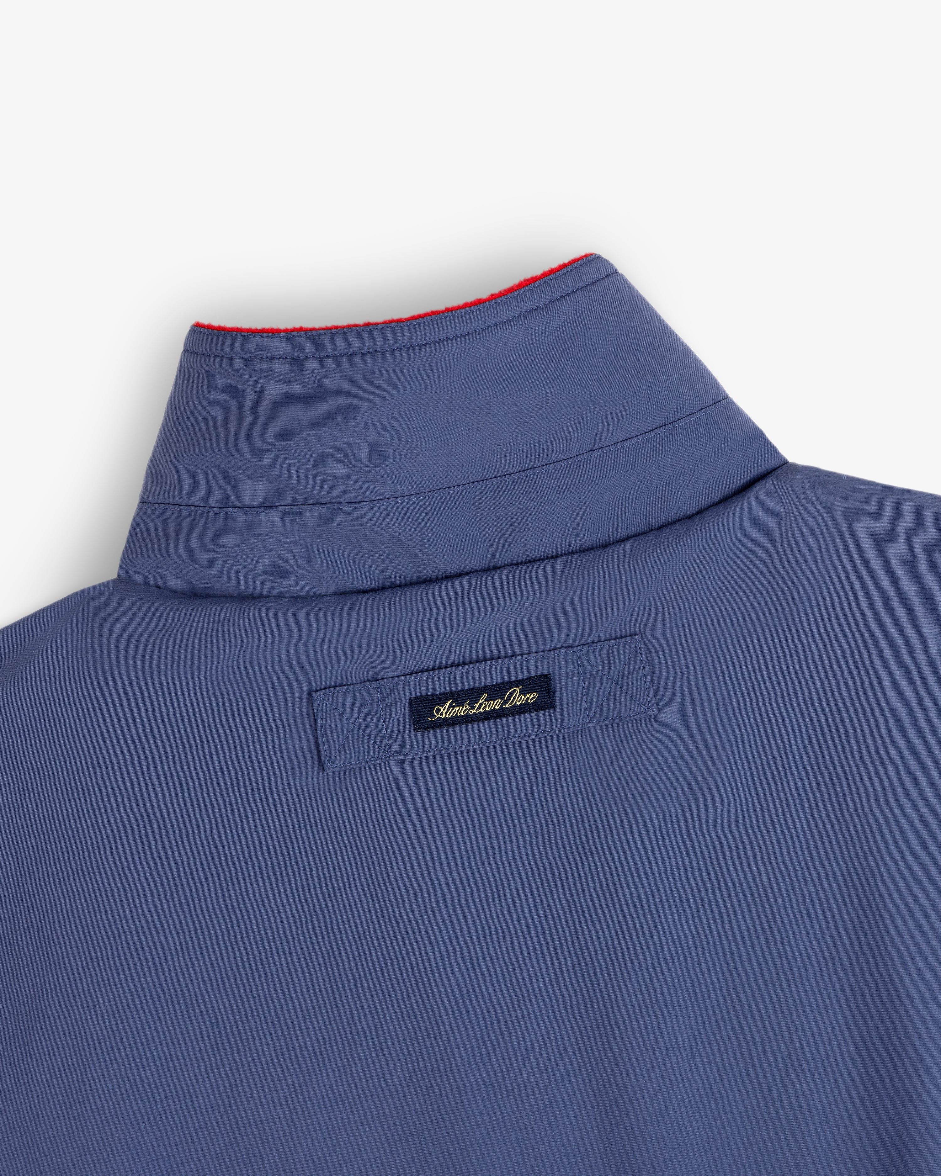 Fleece Lined Sport Windbreaker with tag reading Adam Lippes Live and red stitching along the inside collar edge.
