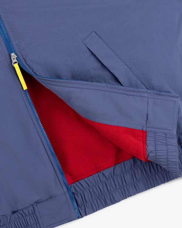 Fleece Lined Sport Windbreaker with blue zipper, yellow pull, and red fleece lining visible at the opening.