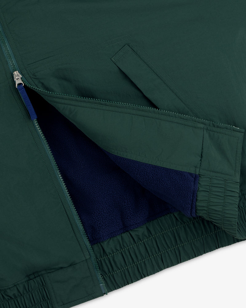 Close-up of the Fleece Lined Sport Windbreaker showing its zip pocket and visible blue fleece lining.