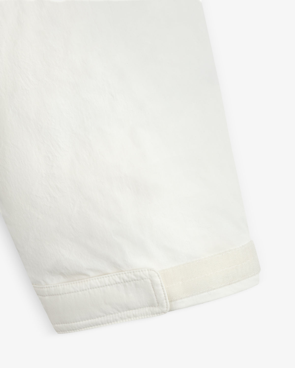 Close-up of a Down-Filled Surplus Parka white coat sleeve with a hook-and-loop adjustable cuff.