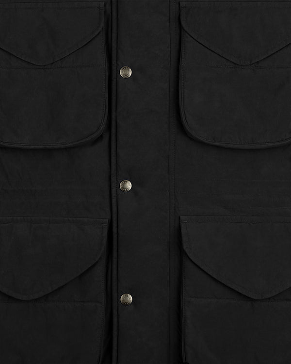 Close-up of a black Down-Filled Surplus Parka with four large flap pockets and a snap-button front closure.