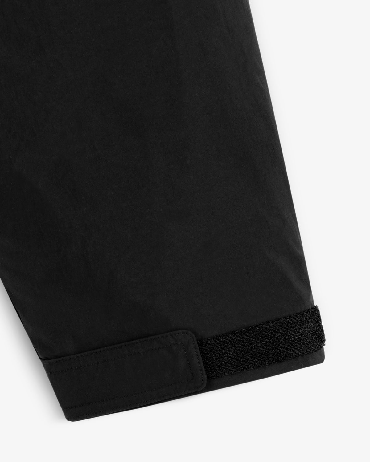 Close-up of a black Down-Filled Surplus Parka sleeve cuff with a velcro strap closure.