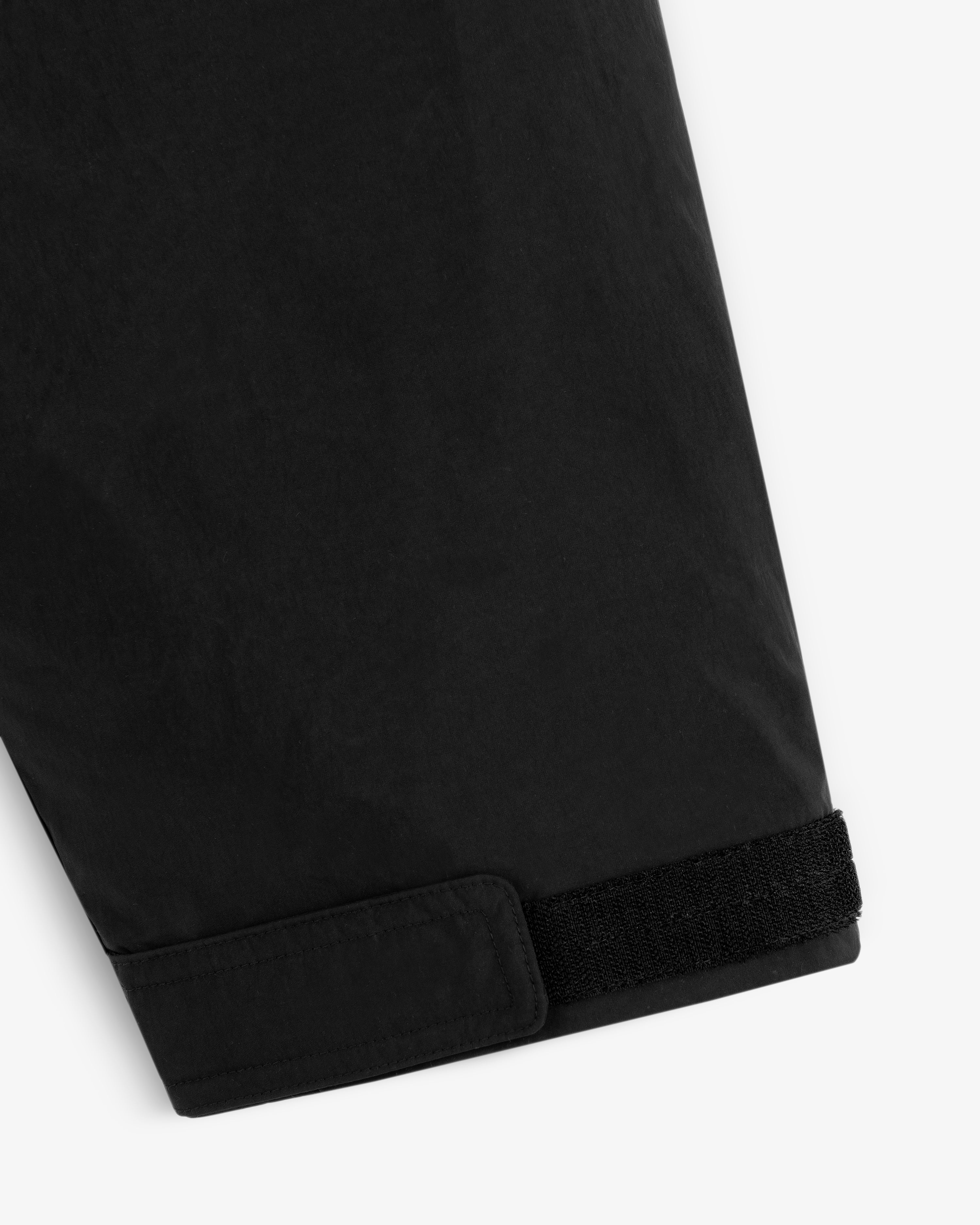Close-up of a black Down-Filled Surplus Parka sleeve cuff with a velcro strap closure.