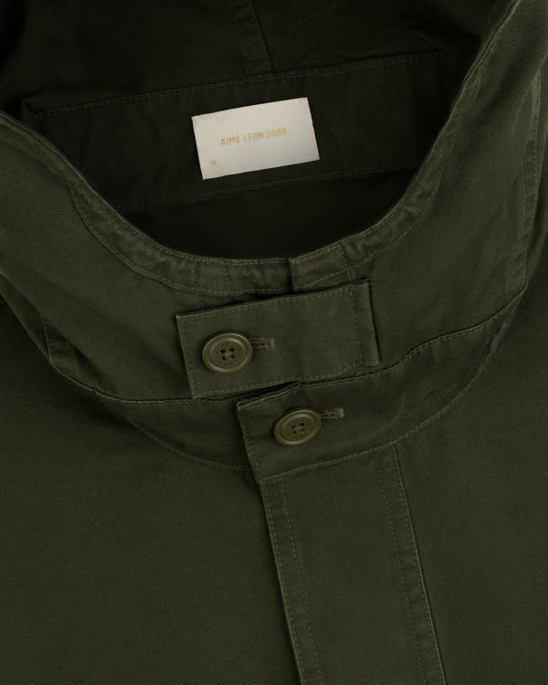 Close-up of the olive green collar and buttoned placket of a Garment Washed Anorak.