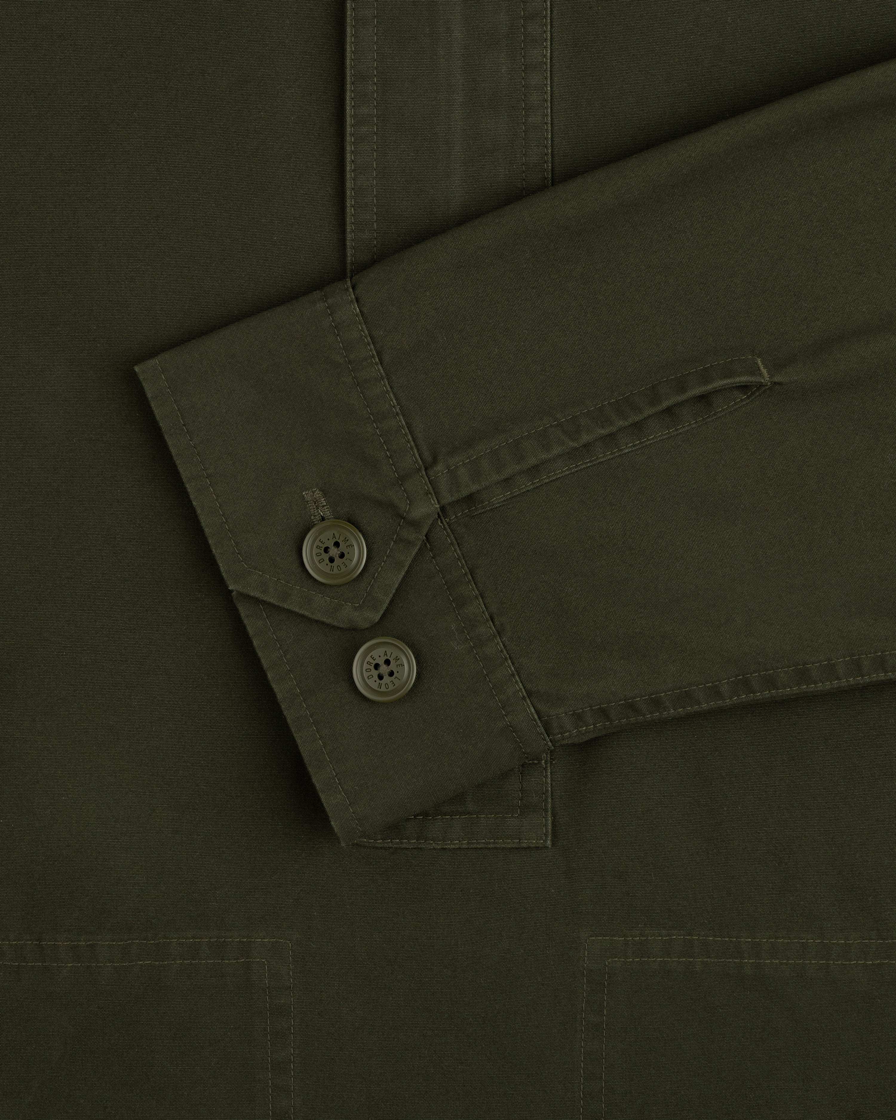 Olive green Garment Washed Anorak sleeve cuff with two buttoned closures.
