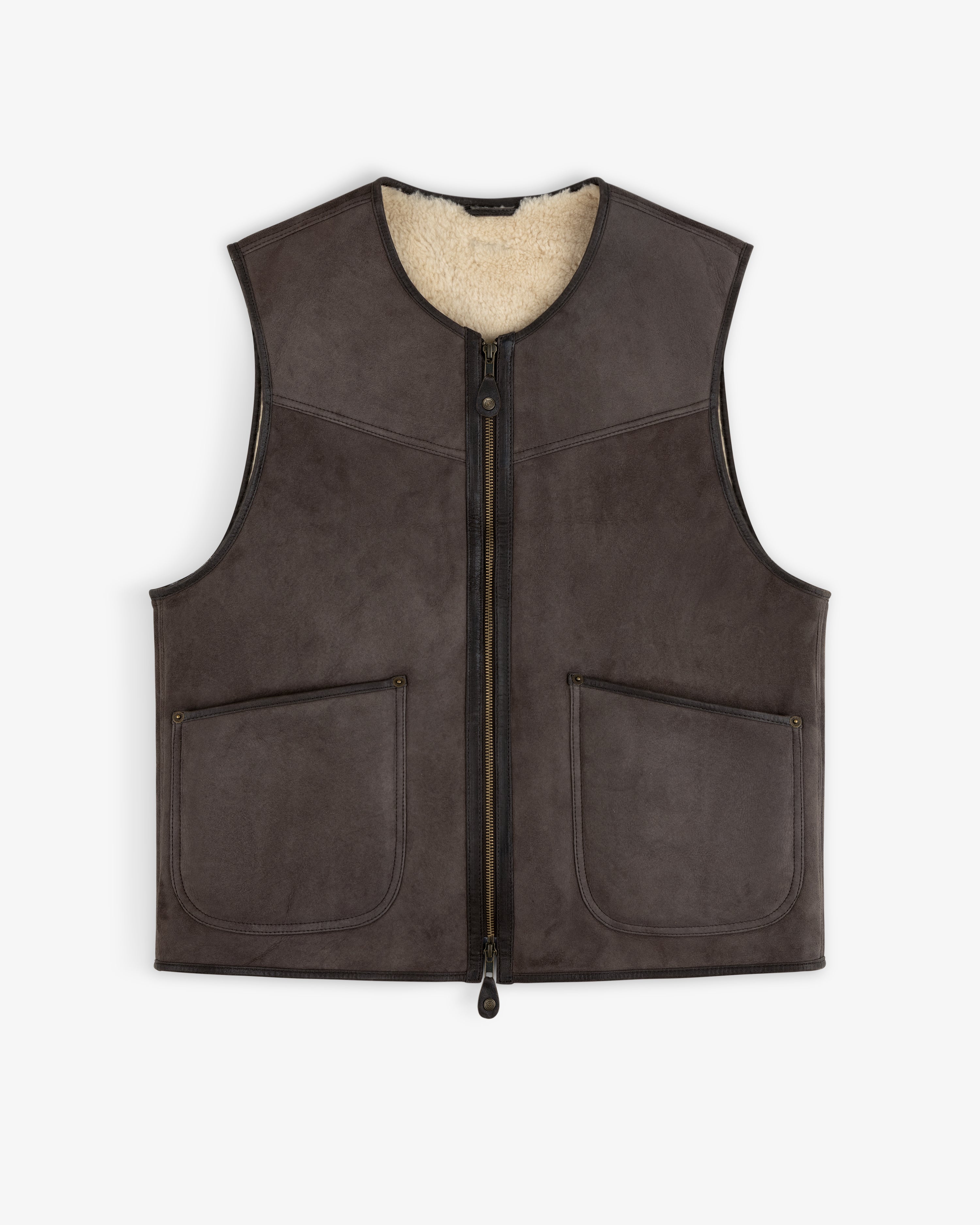 Shearling Biker Vest in dark brown suede with a cream shearling lining, front zipper, and two patch pockets.