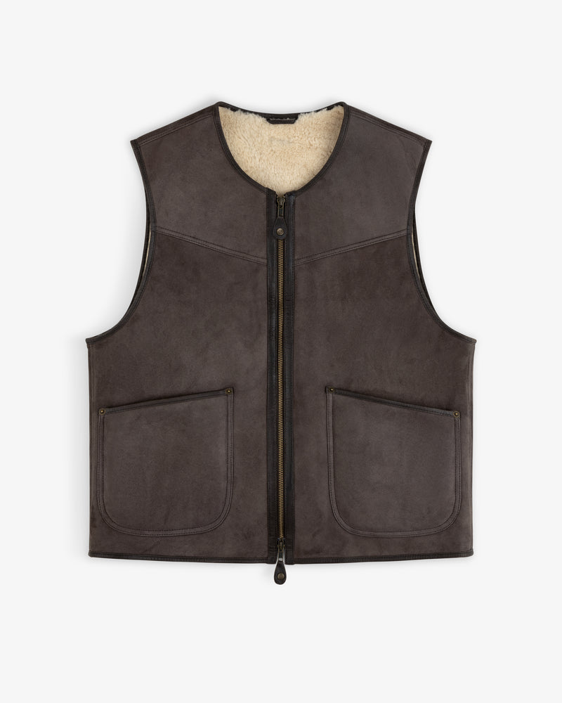 Shearling Biker Vest in dark brown suede with a cream shearling lining, front zipper, and two patch pockets.