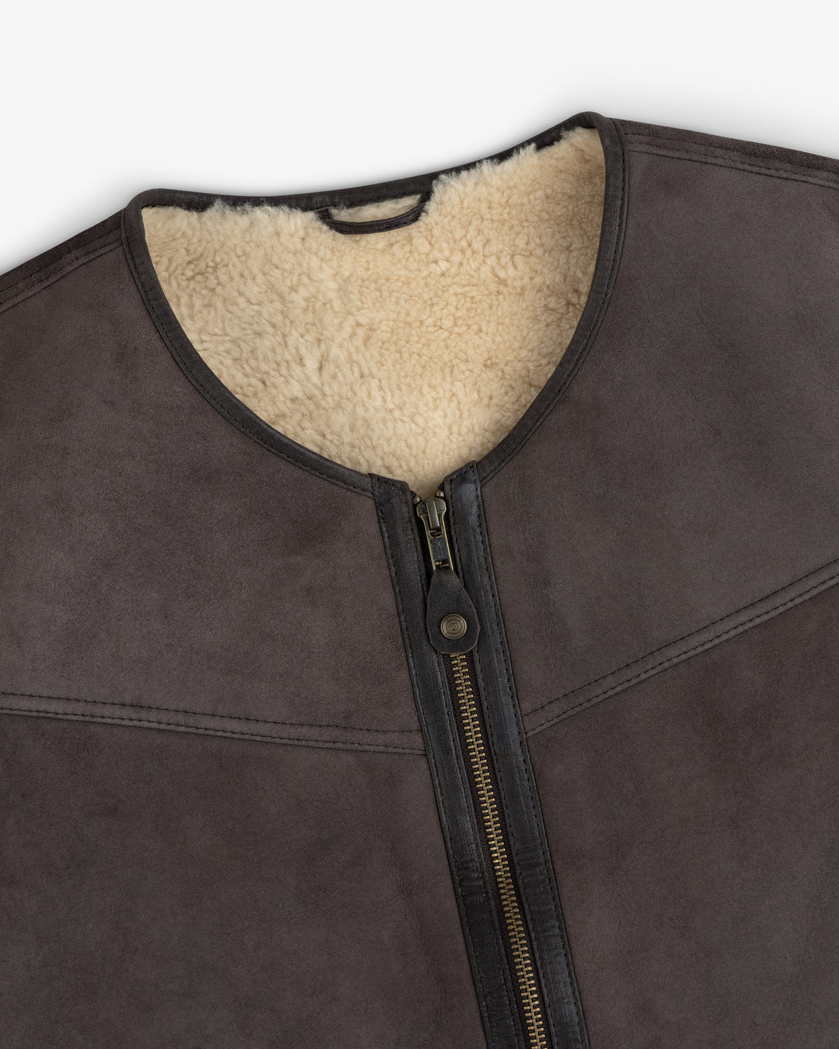 Shearling Biker Vest in dark brown with a cream-colored shearling lining and a center front zipper.