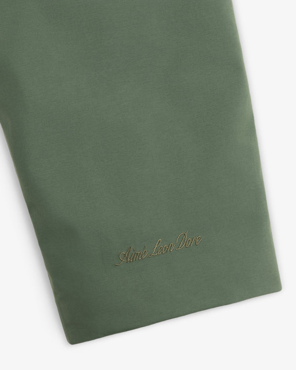 Olive green sleeve of the GORE-TEX Down Filled Fishtail Parka with an embroidered script logo near the cuff.