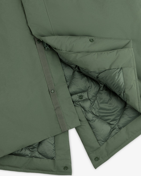 Olive green GORE-TEX Down Filled Fishtail Parka showing the quilted lining, front zipper, and snap button placket.