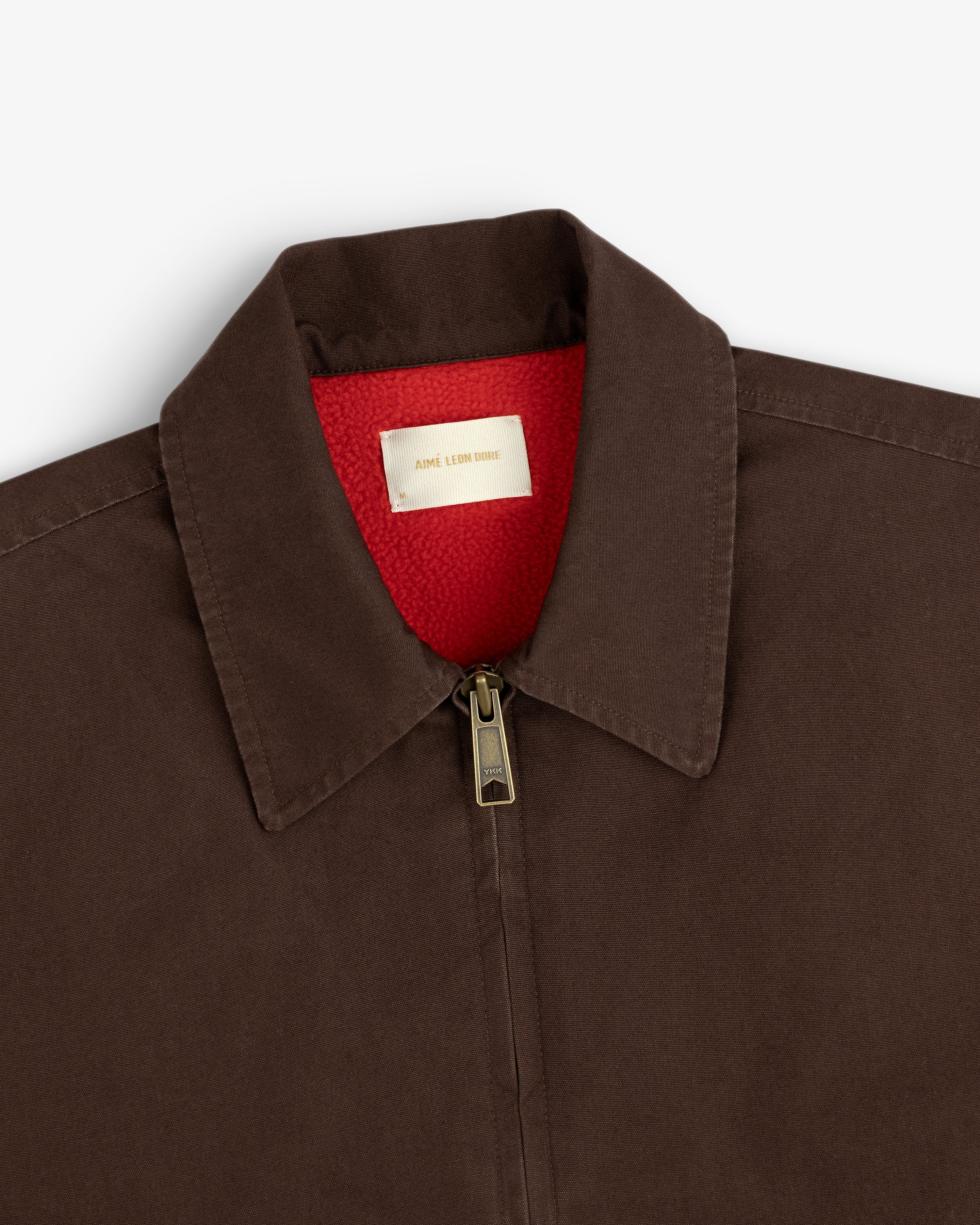 Fleece Lined Mechanic Jacket in dark brown with a bright red fleece lining and a zippered collar.