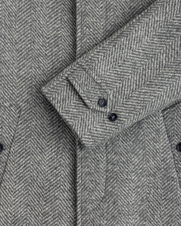 Wool Herringbone Overcoat sleeve in gray herringbone with two dark buttons.