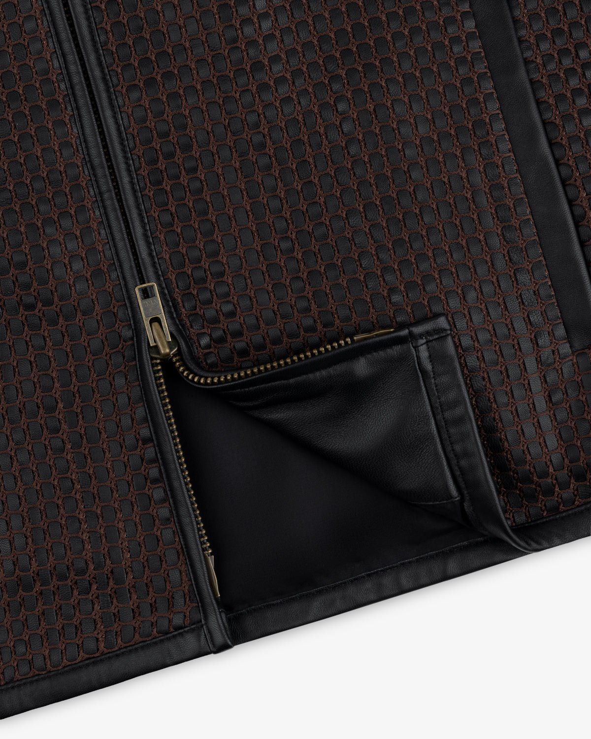 Close-up of a Woven Leather Jacket featuring a brown and black grid pattern with a metallic zipper and black leather trim.