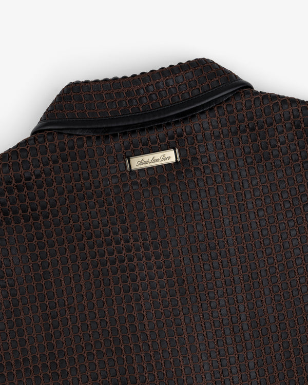 Close-up of a brown and black Woven Leather Jacket collar with a metallic brand tag at the neckline.