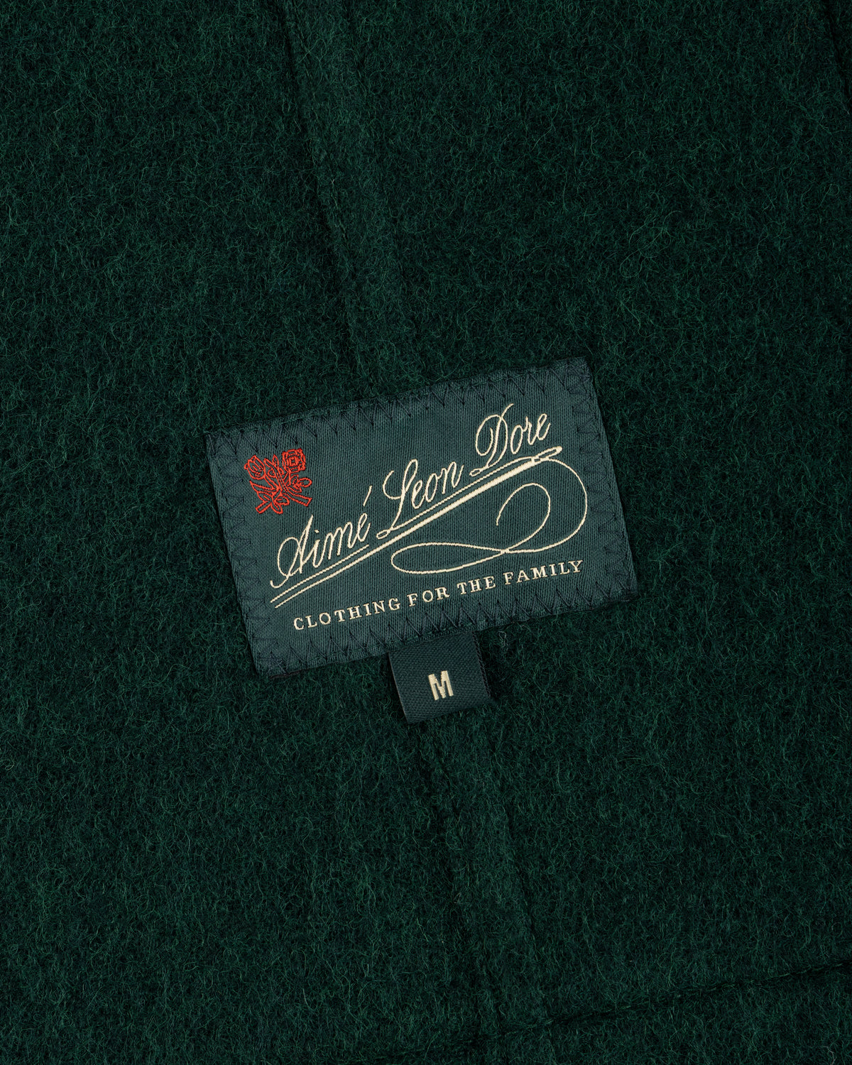 Dark green textured wool Wool Sport Coat with an Aimé Leon Dore brand label and a size medium tag.