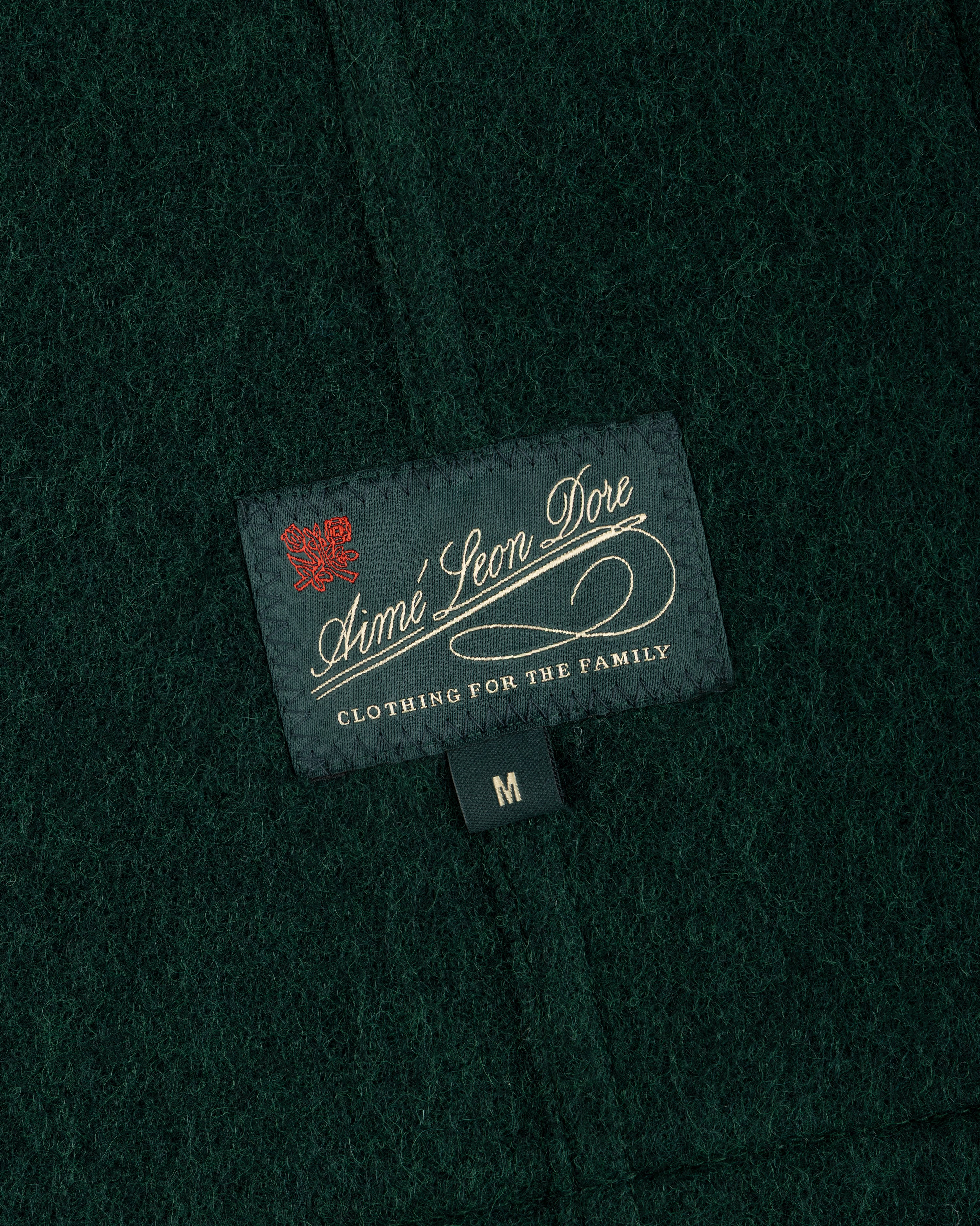 Dark green textured wool Wool Sport Coat with an Aimé Leon Dore brand label and a size medium tag.