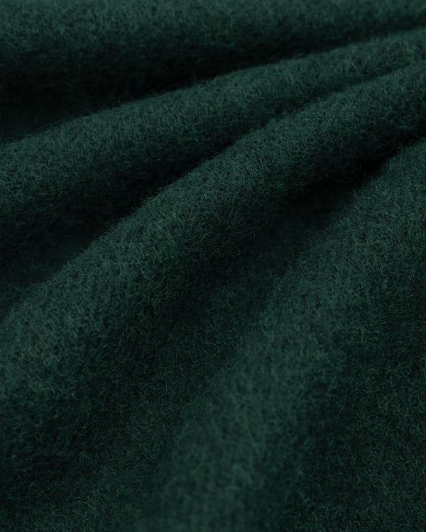 Dark green, textured Wool Sport Coat fabric folded in soft waves.