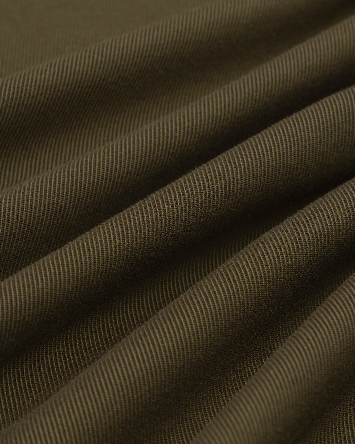 Close-up of folds in olive green fabric with a diagonal weave on a Single-Breasted Wool Blend Suit Jacket.