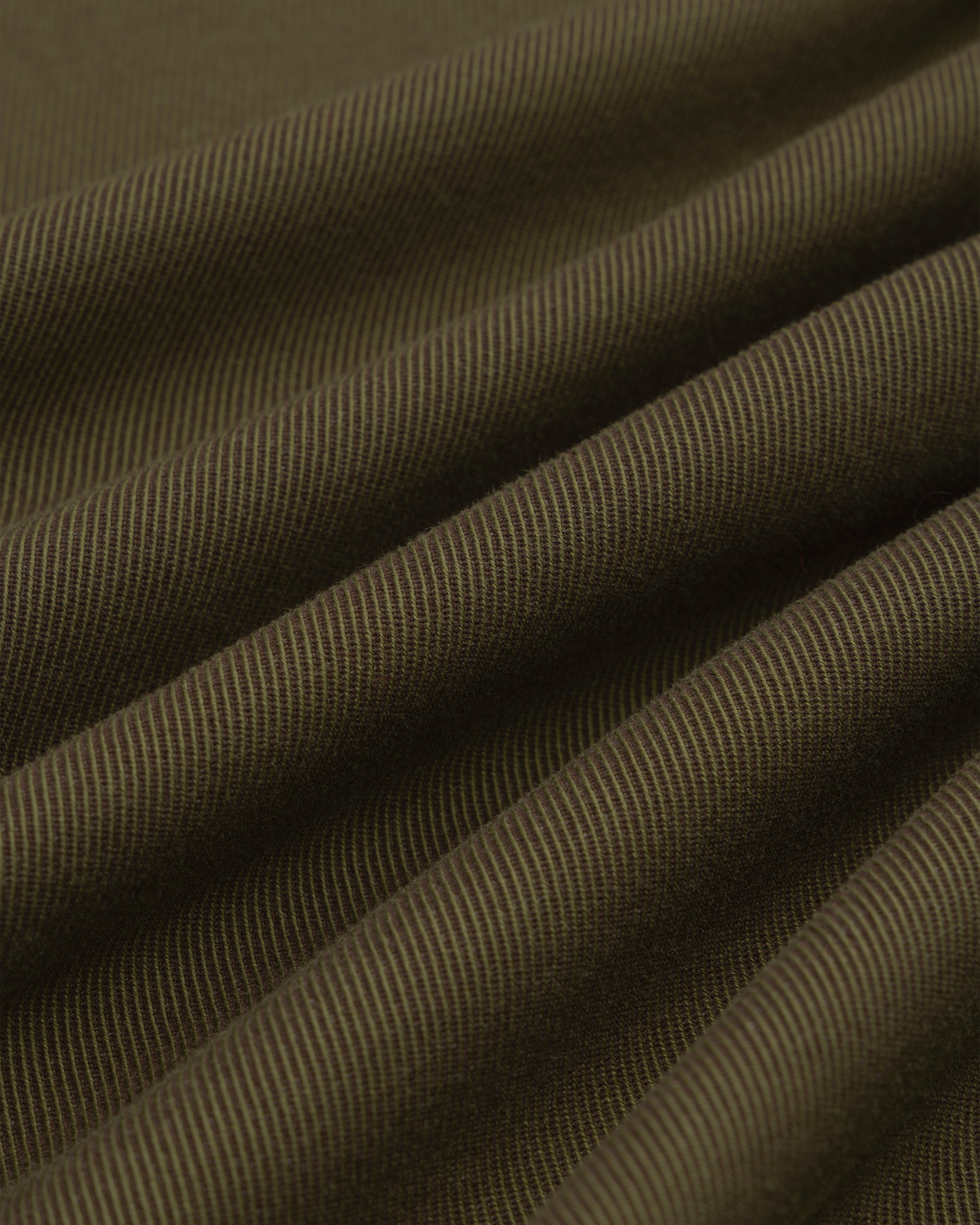 Close-up of folds in olive green fabric with a diagonal weave on a Single-Breasted Wool Blend Suit Jacket.