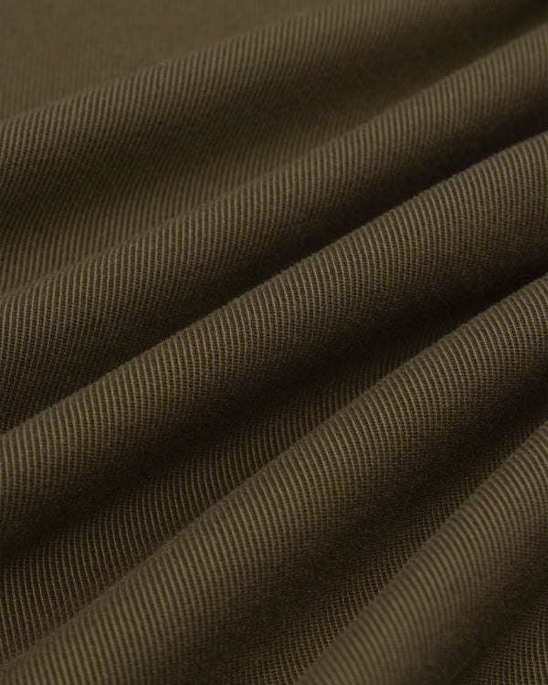 Close-up of folds in olive green fabric with a diagonal weave on a Single-Breasted Wool Blend Suit Jacket.