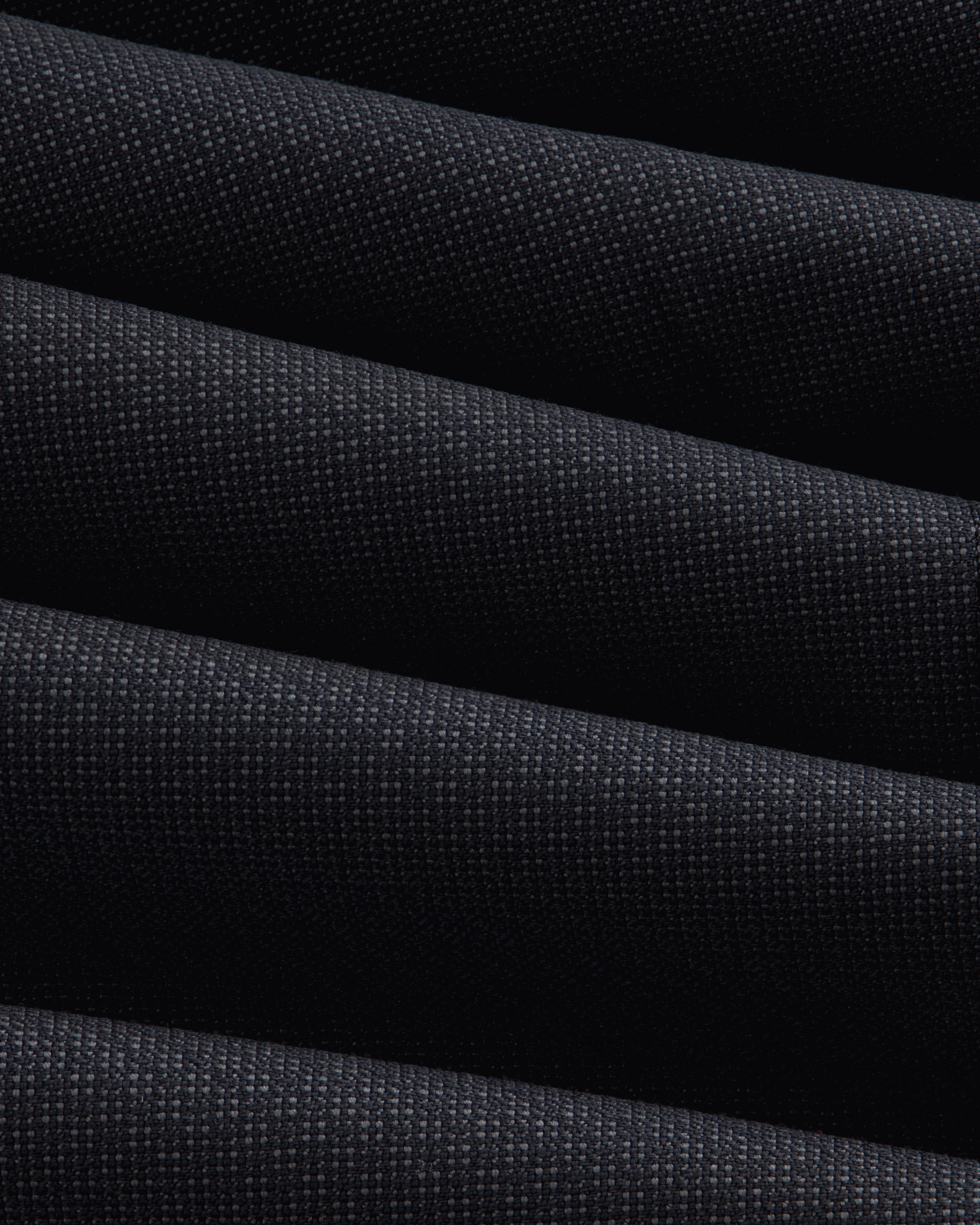 Close-up of a Double-Breasted Wool Jacquard Suit Jacket featuring dark, textured fabric with prominent diagonal folds.