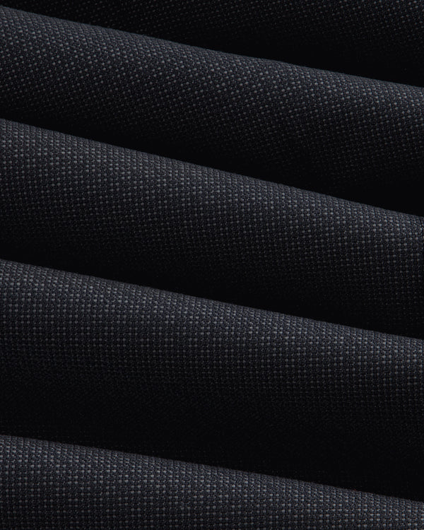 Close-up of a Double-Breasted Wool Jacquard Suit Jacket featuring dark, textured fabric with prominent diagonal folds.