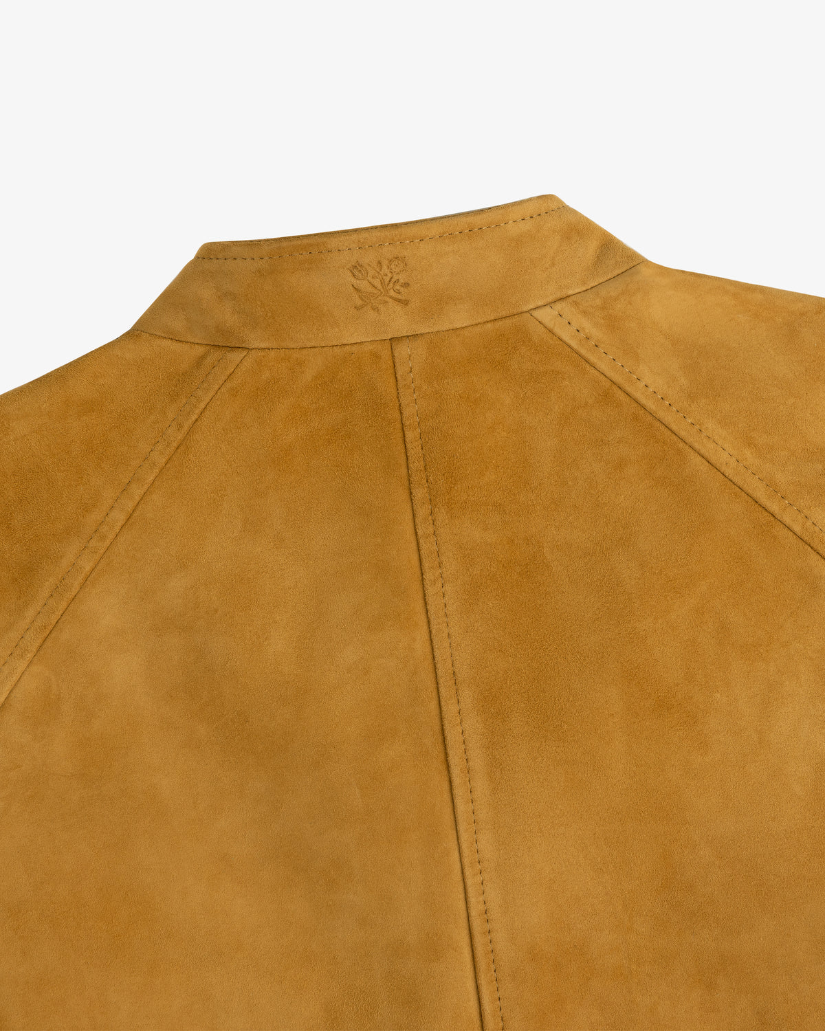 Close-up of the Suede Cafe Racer Jacket’s upper back seam and subtle embossed logo near the collar.