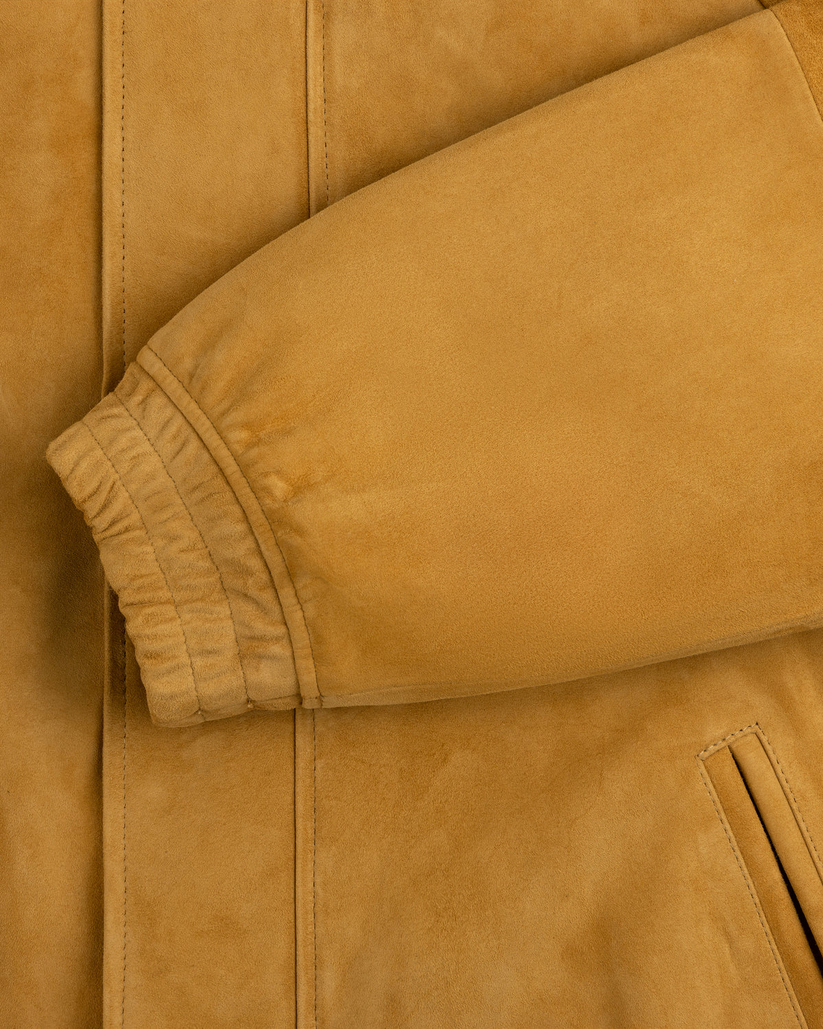 Close-up of Suede Cafe Racer Jacket sleeve with ribbed cuff and slanted pocket visible.