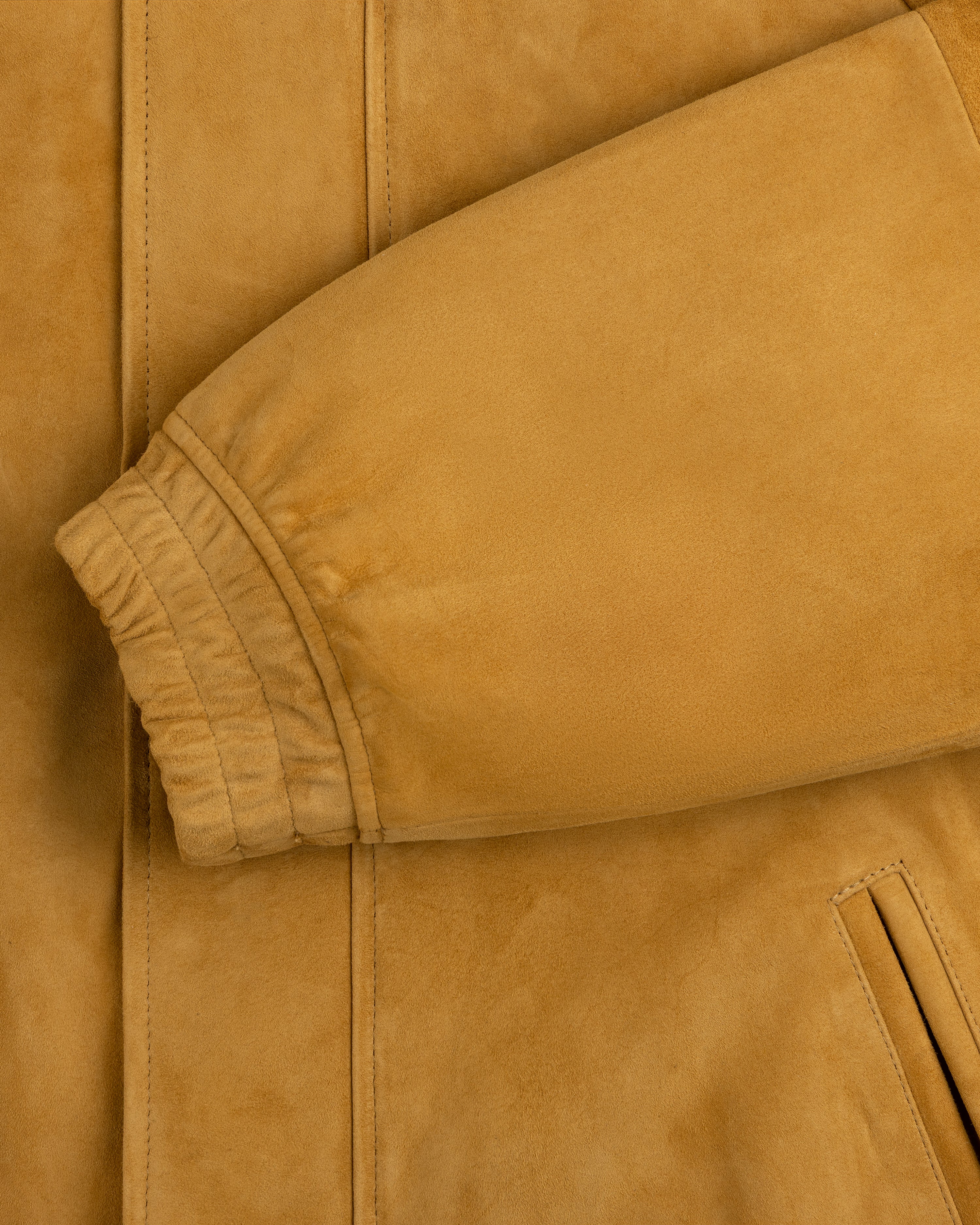 Close-up of Suede Cafe Racer Jacket sleeve with ribbed cuff and slanted pocket visible.