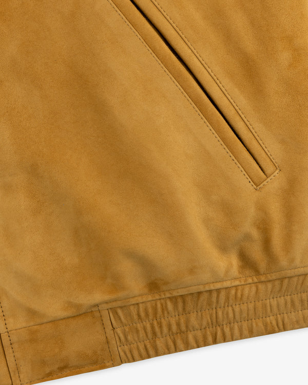 Close-up of Suede Cafe Racer Jacket in tan, highlighting a slanted pocket and stitching near the hem.