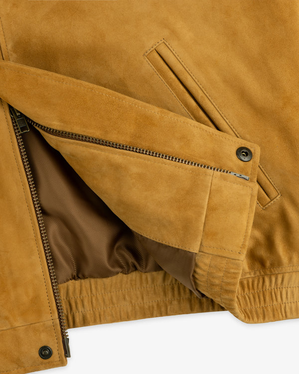 Close-up of the Suede Cafe Racer Jacket, featuring a zippered pocket and brown inner lining.
