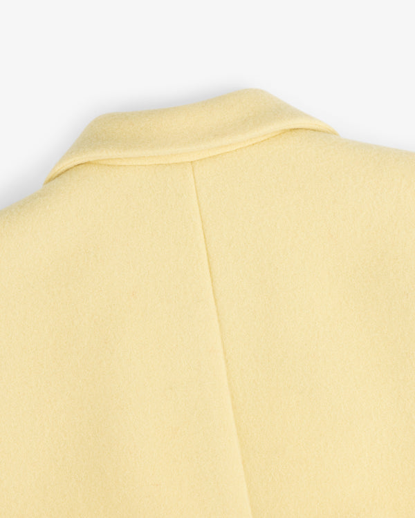 Close-up view of the collar and back seam of a pale yellow Wool Sportcoat.